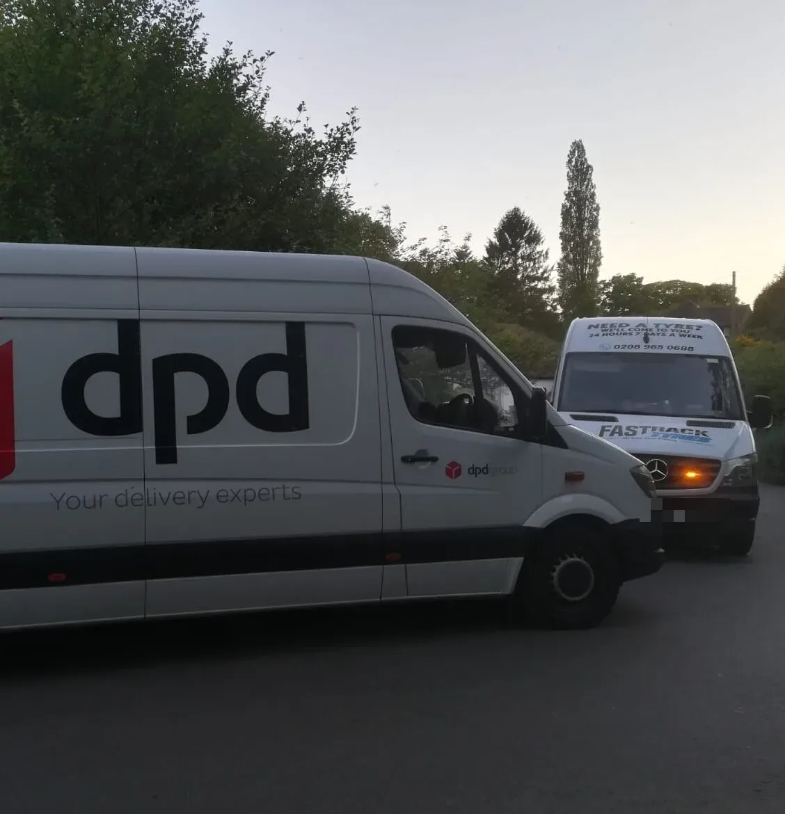 Fastrack Tyres van on a roadside call-out beside a DPD courier delivery van