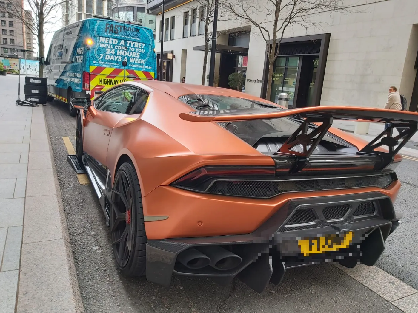Matte-copper Lamborghini Huracan with carbon wing on a mobile tyre call-out