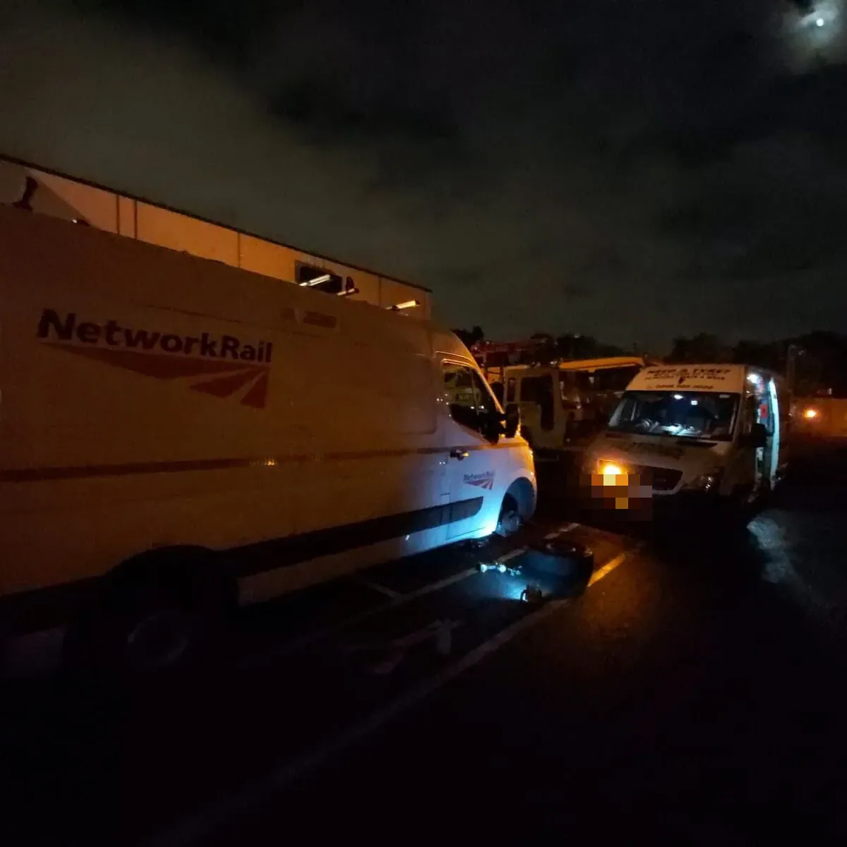 Fastrack Tyres van on a night call-out beside a Network Rail fleet van having a wheel changed