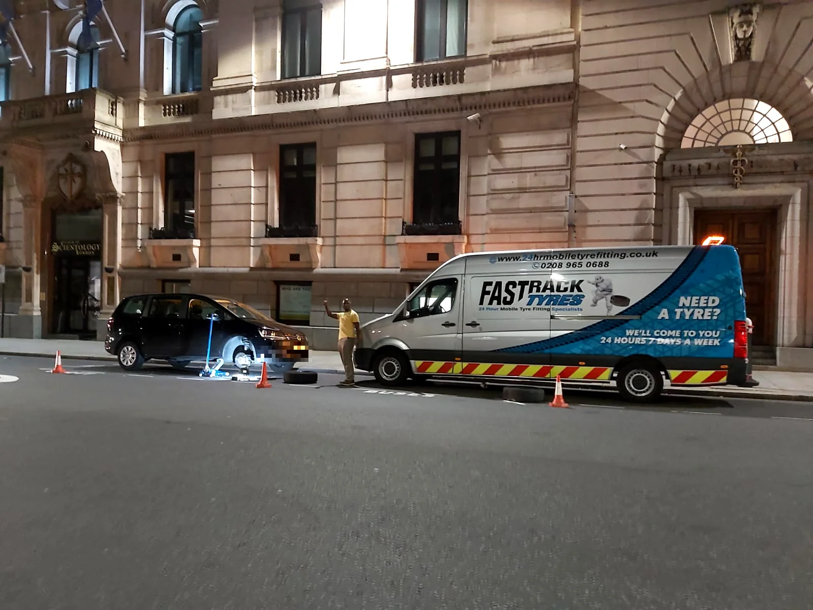 Roadside spare wheel fitting on a family car in London